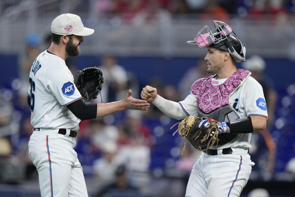 Miami Marlins relief pitcher Dylan Floro, left, and catcher Nick Fortes congratulate each other after the Marlins beat the Cincinnati Reds 3-1during a baseball game, Sunday, May 14, 2023, in Miami. (AP Photo/Wilfredo Lee)