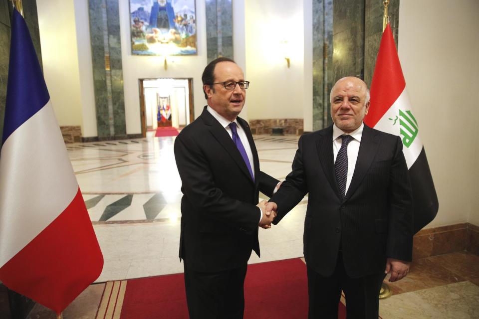 Iraq's Prime Minister Haider al-Abadi, right, greets French President Francois Hollande prior to their meeting in Baghdad, Iraq, Monday, Jan. 2, 2017. Hollande is in Iraq for a one-day visit. (AP Photo/Christophe Ena, Pool)