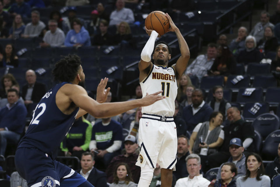 Denver Nuggets' Monte Morris lines up a shot against Minnesota Timberwolves' Karl-Anthony Towns in the second half of an NBA basketball game Monday, Jan. 20, 2020, in Minneapolis. Denver won 107-100. (AP Photo/Stacy Bengs)