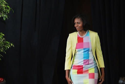 US First Lady Michelle Obama arrives for a press conference to announce changes to Disney's nutrition guideline policy at the Newseum in Washington