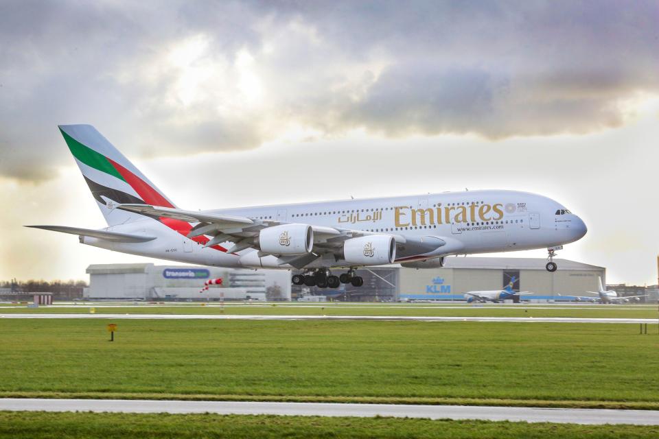 An Emirates airplane, the double-decker Airbus A380 with registration A6-EOO is approaching Amsterdam Schiphol International Airport arriving at runway 27