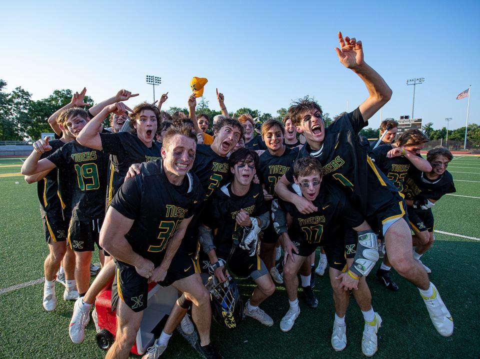 The St. X Tigers lacrose team mugged for the cameras after defeating the Trinity Shamrocks 13-6 for their fourth-straight boys lacrosse title. May 20, 2022