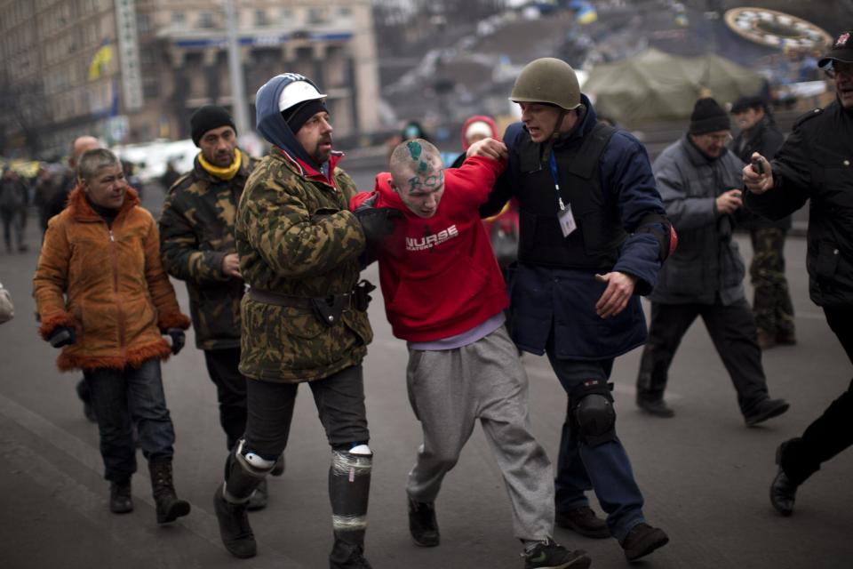 Anti-Yanukovych protesters detain a suspected thief in Kiev's Independence Square, the epicenter of the country's current unrest, Ukraine, Tuesday, Feb. 25, 2014. The Ukrainian parliament on Tuesday delayed the formation of a new government, reflecting political tensions and economic challenges following the ouster of the Russia-backed president. Parliament speaker Oleksandr Turchinov, who was named Ukraine's interim leader after President Viktor Yanukovych fled the capital, said that a new government should be in place by Thursday, instead of Tuesday, as he had earlier indicated. (AP Photo/Emilio Morenatti)