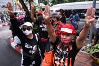 Pro-democarcy protesters stand outside the criminal court building demanding a representative be allowed inside were two leader still detained at the criminal court in Bangkok