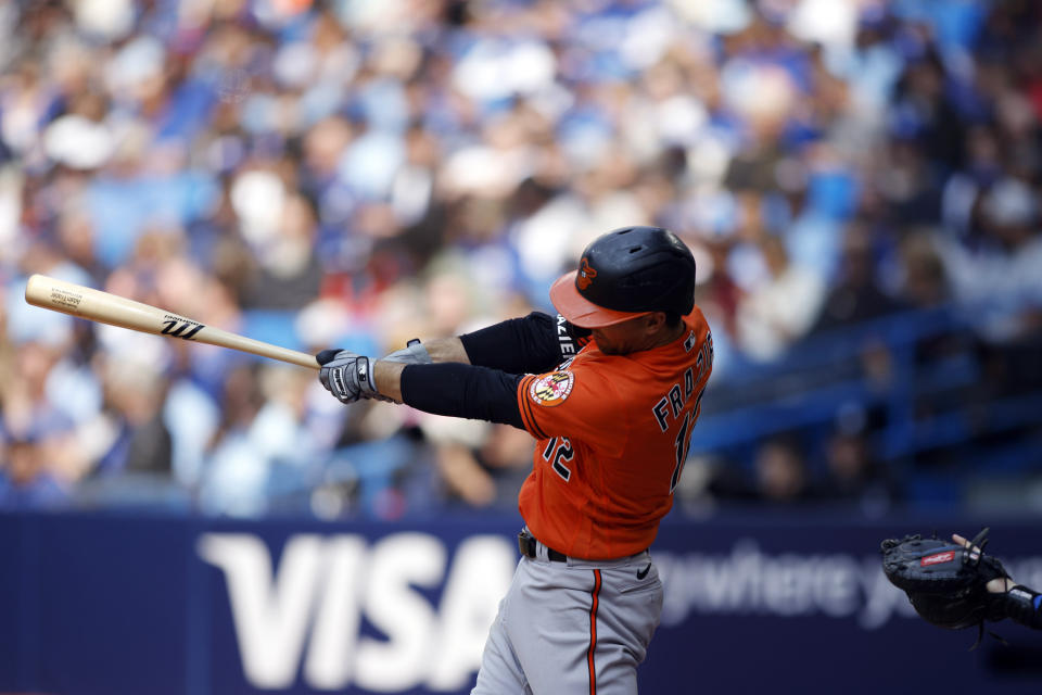 Baltimore Orioles' Adam Frazier (12) hits a triple during the second inning of a baseball game against the Toronto Blue Jays in Toronto, Saturday, May 20, 2023. (Cole Burston/The Canadian Press via AP)