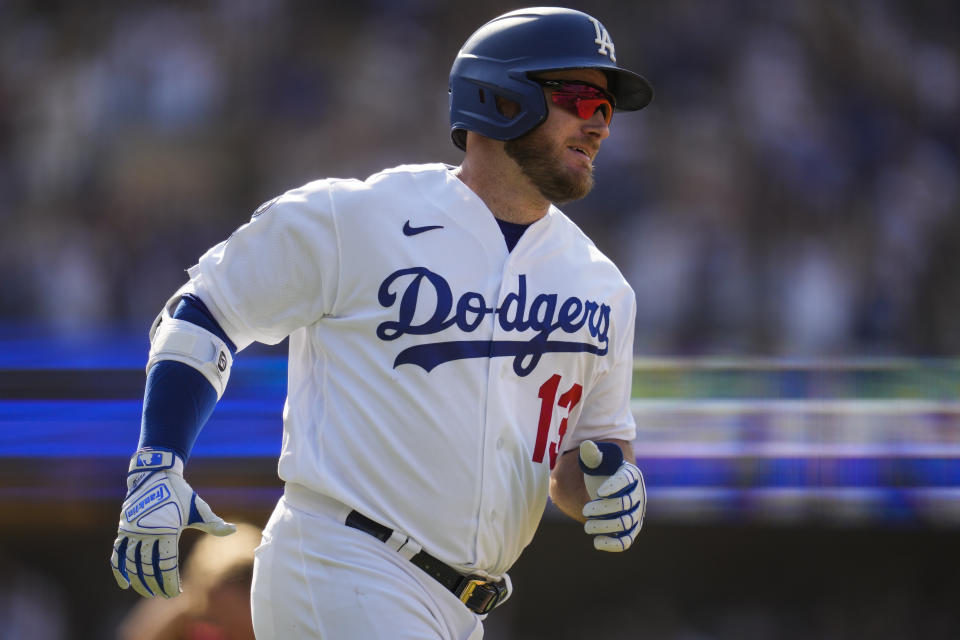 Los Angeles Dodgers' Max Muncy (13) runs the bases after hitting a home run during the ninth inning of a baseball game against the Arizona Diamondbacks Sunday, July 11, 2021, in Los Angeles. Zach Reks and Mookie Betts also scored. The homer won the game for the Dodgers 7-4. (AP Photo/Ashley Landis)