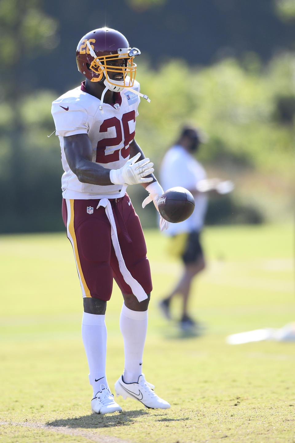 Washington running back Adrian Peterson (26) tosses the ball during practice at the team's NFL football training facility, Monday, Aug. 24, 2020, in Ashburn, Va. (AP Photo/Nick Wass)