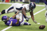 Minnesota Vikings quarterback Kirk Cousins (8) fumbles as he is sacked by Denver Broncos defensive tackle Shelby Harris (96) during the first half of an NFL football game, Sunday, Nov. 17, 2019, in Minneapolis. The Broncos recovered the fumble. (AP Photo/Jim Mone)