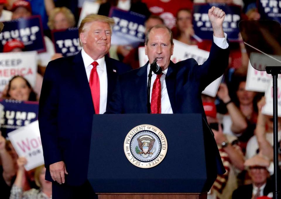 Then-President Donald Trump, left, gives his support to Dan Bishop, right, a Republican who was running for the special North Carolina 9th District U.S. Congressional race as he speaks at a rally in Fayetteville, N.C., Monday, Sept. 9, 2019.