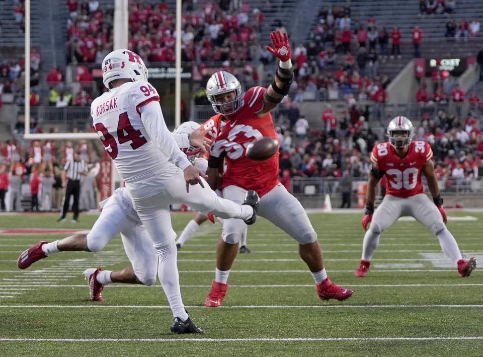 Ohio State defensive tackle Hero Kanu tries to get a hand on a punt by Rutgers' Adam Korsak.