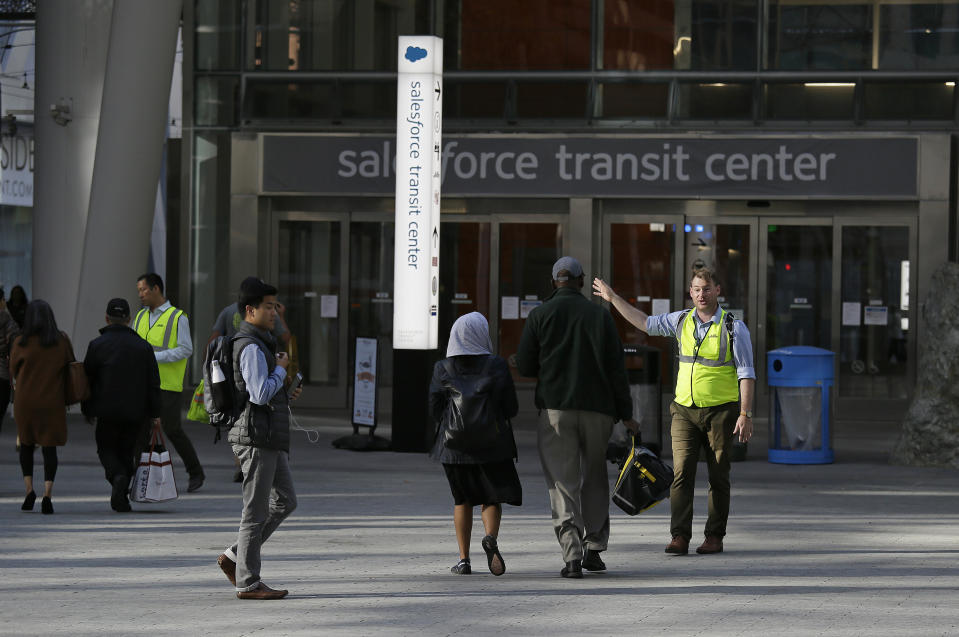 People are directed around the Salesforce Transit Center following its closure Tuesday, Sept. 25, 2018, in San Francisco. San Francisco officials shut down the city's celebrated new $2.2 billion transit terminal Tuesday after discovering a crack in a support beam under the center's public roof garden. Coined the "Grand Central of the West," the Salesforce Transit Center opened in August near the heart of downtown after nearly a decade of construction. It was expected to accommodate 100,000 passengers each weekday, and up to 45 million people a year. (AP Photo/Eric Risberg)