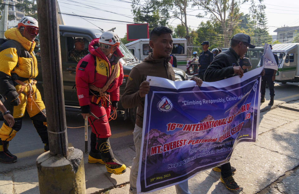 People from the mountaineering community, in climbing gear participate in a rally to mark the 70 anniversary of the first ascent of Mount Everest in Kathmandu, Nepal, Monday, May 29, 2023. The 8,849-meter (29,032-foot) mountain peak was first scaled by New Zealander Edmund Hillary and his Sherpa guide Tenzing Norgay on May 29, 1953. (AP Photo/Niranjan Shrestha)