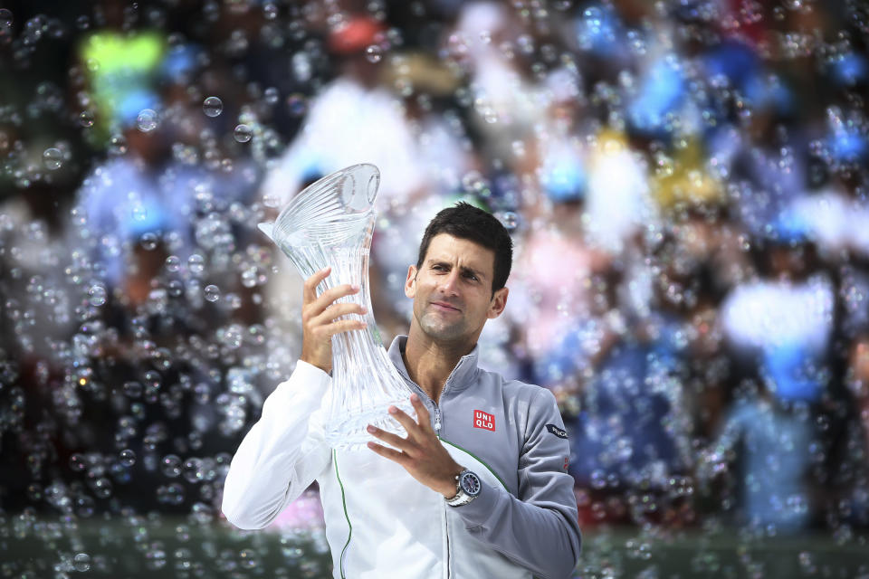 Novak Djokovic, of Serbia, holds his trophy after winning the Sony Open Tennis in Key Biscayne, Fla., Sunday, March 30, 2014, in Key Biscayne, Fla., defeating Rafeal Nadal, of Spain, 6-3, 6-3. (AP Photo/J Pat Carter)