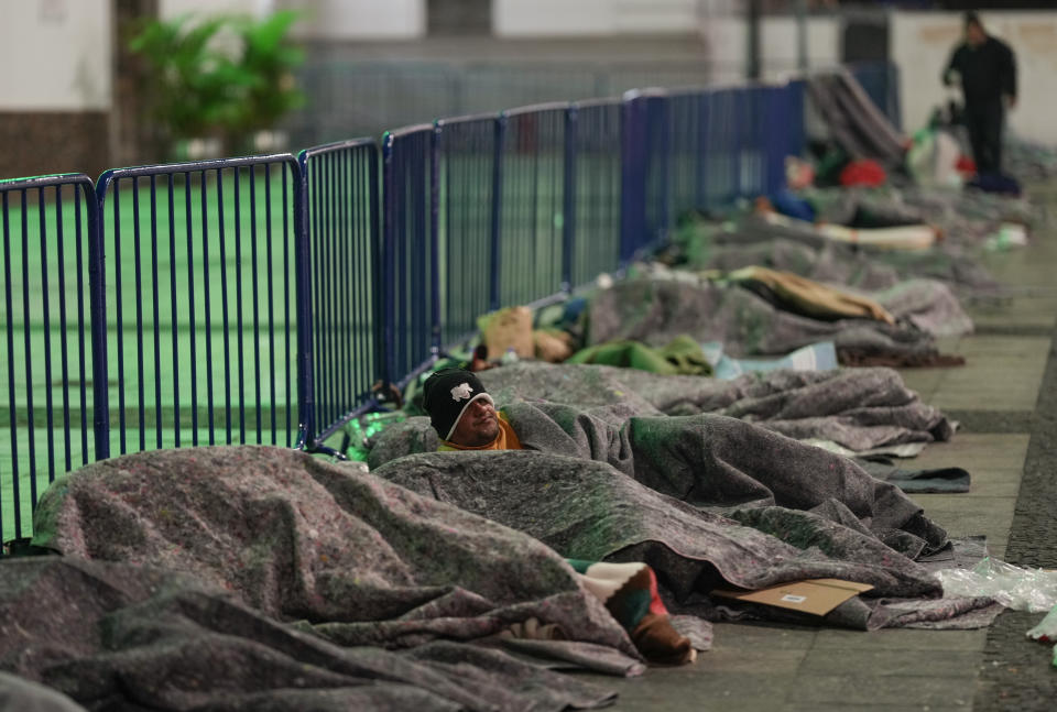 Homeless people sleep at Patio do Colegio Square during a cold night in downtown Sao Paulo, Brazil, early Friday, May 20, 2022. The homeless population in Sao Paulo has increased 30% during the COVID-19 pandemic, a recent census shows. (AP Photo/Andre Penner)