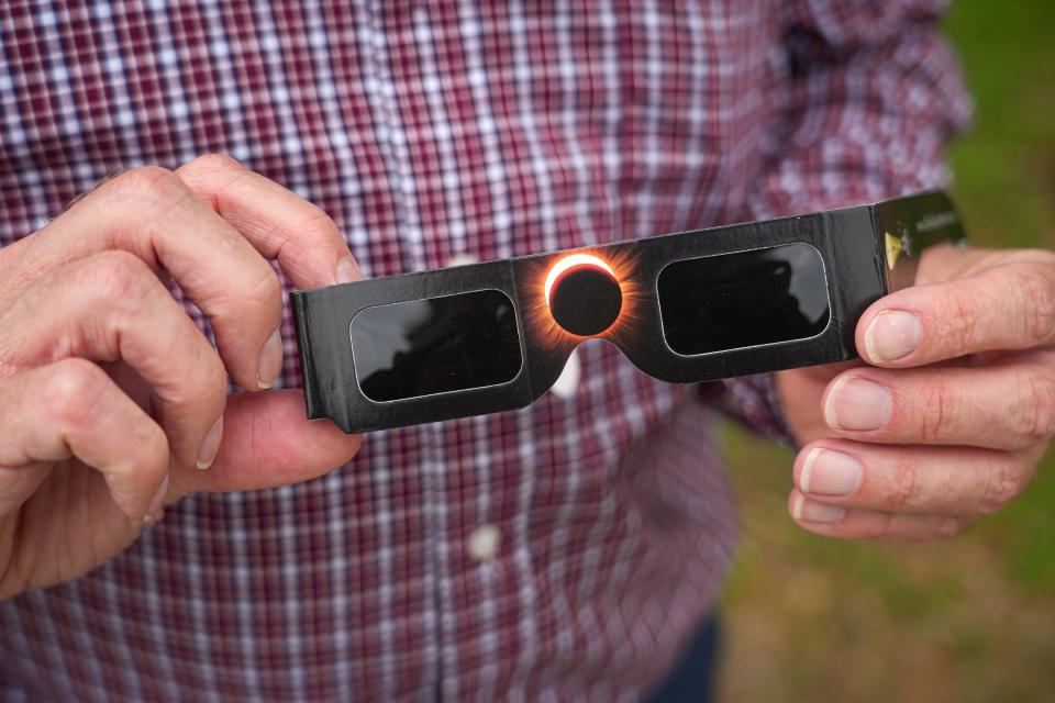 Tovard Hessel, an engineering scientist at the Space and Geophysics lab at the University of Texas at Austin, holds a set of his eclipse glasses on Monday, April 1, 2024. Hessel started his own small business called The Eclipse Store where he sells eclipse glasses that meet ISO safety standards, mugs and shirts, and offers free information and interactive maps on the April 8, 2024 eclipse.