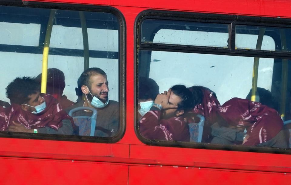 A group of people thought to be migrants wait on a holding bus after being brought in to Dover, Kent (Gareth Fuller/PA) (PA Wire)