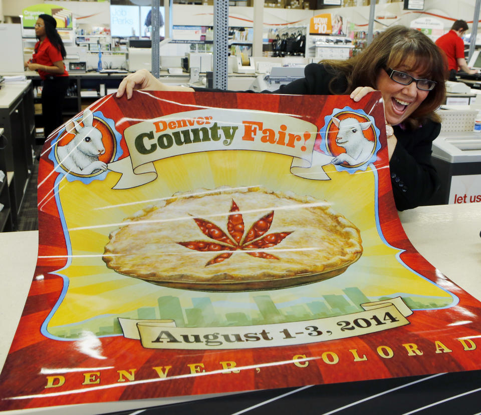 Dana Cain, director of the Denver County Fair, shows a poster advertising the fair at a print shop in Denver, Monday Jan. 27, 2014. Colorado's Denver County is adding cannabis-themed contest to its 2014 summer fair. (AP Photo/Ed Andrieski)