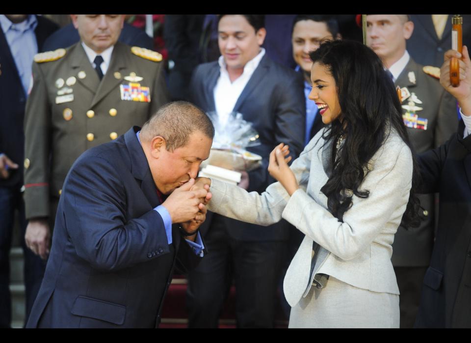 Venezuelan President Hugo Chavez (L) kisses the hand of Venezuelan Miss World 2011 Ivian Sarcos (R) during a meting in Miraflores Presidential Palace in Caracas, on January 04, 2011. AFP PHOTO / Leo RAMIREZ (Photo credit should read LEO RAMIREZ/AFP/Getty Images)