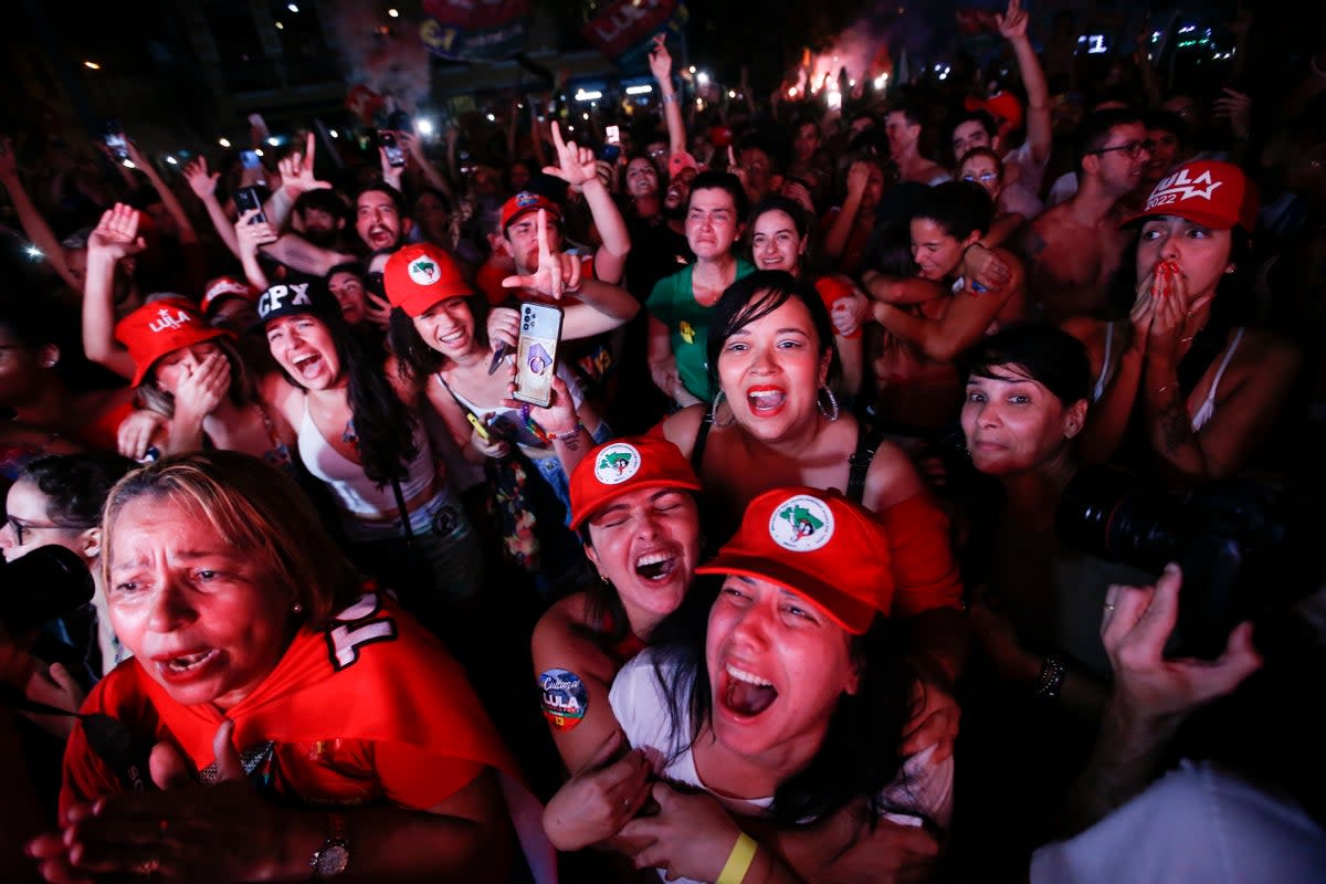 Supporters of former Brazilian president Luiz Inacio Lula da Silva react to election results (AP)