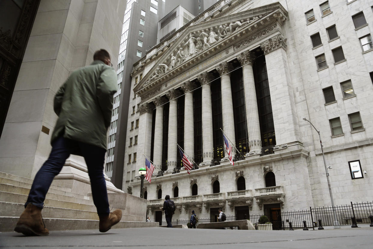 FILE — People pass the front of the New York Stock Exchange, March 22, 2023. Average Wall Street bonuses dropped sharply last year amid lagging profits and recession fears, New York state's comptroller reported Thursday.(AP Photo/Peter Morgan, File)