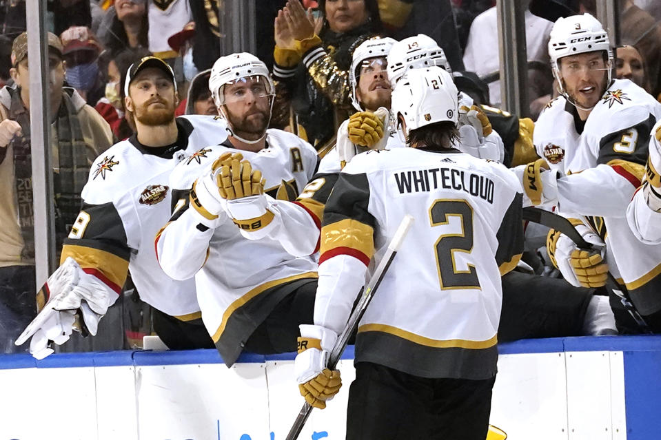 Vegas Golden Knights defenseman Zach Whitecloud (2) is congratulated after scoring a goal against Florida Panthers goaltender Spencer Knight during the first period of an NHL hockey game, Thursday, Jan. 27, 2022, in Sunrise, Fla. (AP Photo/Lynne Sladky)