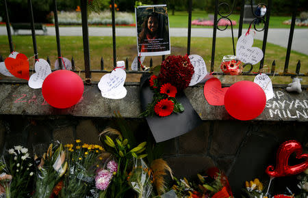 A picture of one of the victims is seen among the flower tribute at a memorial site for victims of the mosque shootings, at the Botanic Gardens in Christchurch, New Zealand, March 18, 2019. REUTERS/Edgar Su