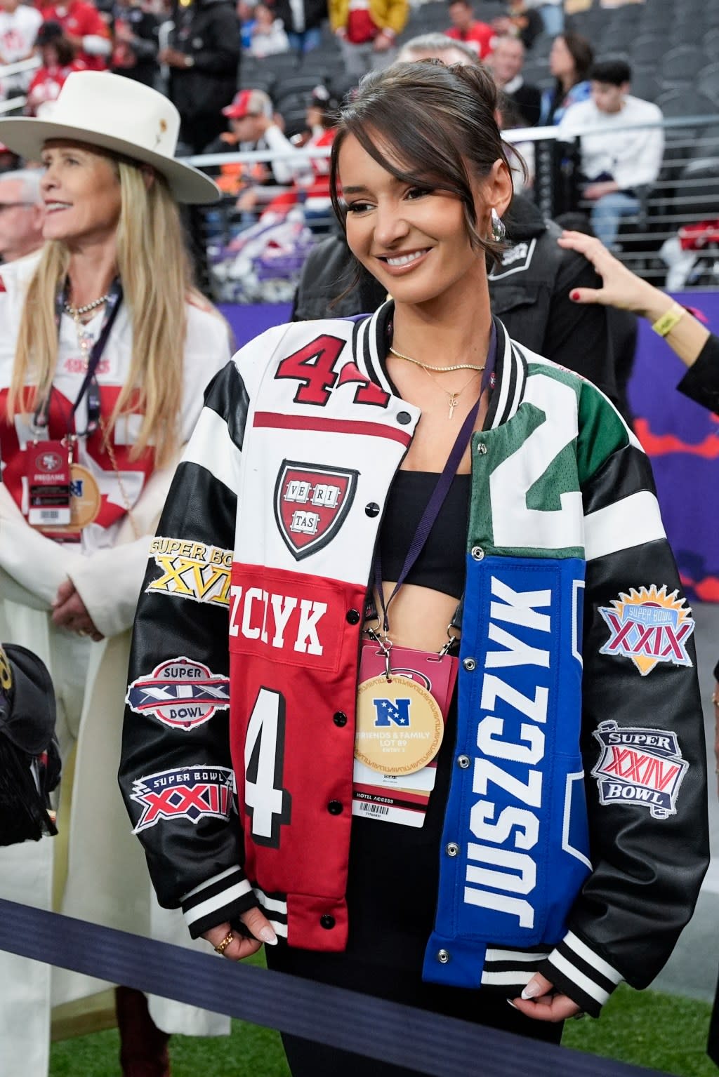 Kristin Juszczyk, wife of San Francisco 49ers fullback Kyle Juszczyk, wears her custom jacket on Sunday, Feb. 11, 2024, in Las Vegas. The 29-year-old designer built a following online by repurposing jerseys into more high-fashion pieces for herself. (AP Photo/John Locher, File)