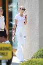 <p>In a white t-shirt, matching bellbottom pants, Le Specs cat-eye sunglasses and holding a STALVEY purse while out in West Hollywood. </p>