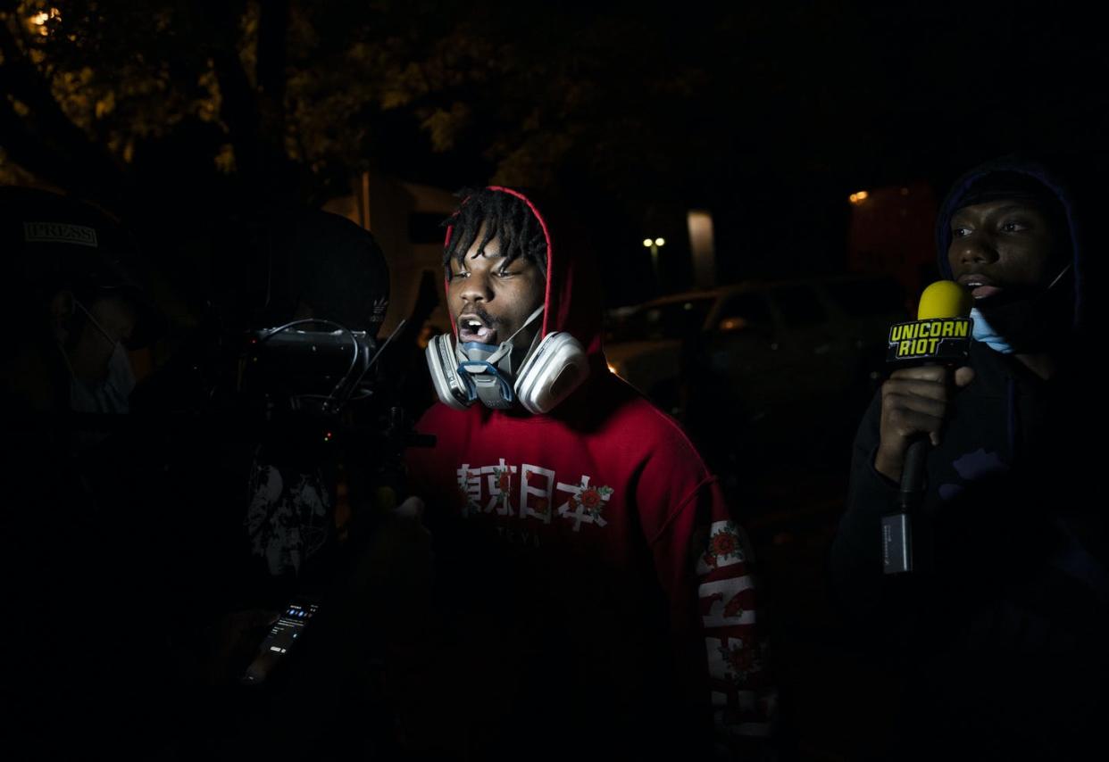<span class="caption">A Unicorn Riot videographer films an interview on the streets of Minneapolis on May 29, 2020.</span> <span class="attribution"><a class="link " href="https://www.gettyimages.com/detail/news-photo/two-men-are-interviewed-by-unicorn-riot-near-the-fifth-news-photo/1216238951?adppopup=true" rel="nofollow noopener" target="_blank" data-ylk="slk:Stephen Maturen/Getty Images;elm:context_link;itc:0;sec:content-canvas">Stephen Maturen/Getty Images</a></span>