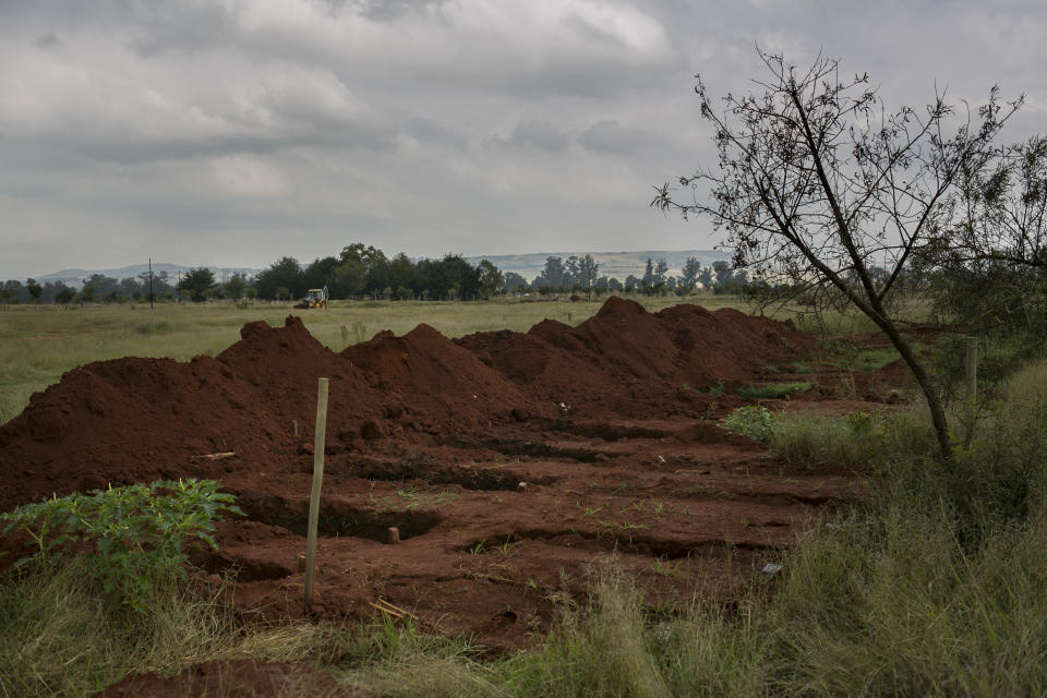 This Wednesday, April 11, 2018 photo shows burial plots in a cemetery outside Johannesburg. At least five bodies of unidentified people are buried on top of each other in each grave. (AP Photo/Bram Janssen)