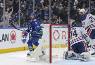Vancouver Canucks' J.T. Miller (9) reacts after scoring against Edmonton Oilers goalie Stuart Skinner (74) as Darnell Nurse (25) watches during the third period of Game 1 of a second-round NHL hockey Stanley Cup playoffs series, Wednesday, May 8, 2024, in Vancouver, British Columbia. (Darryl Dyck/The Canadian Press via AP)