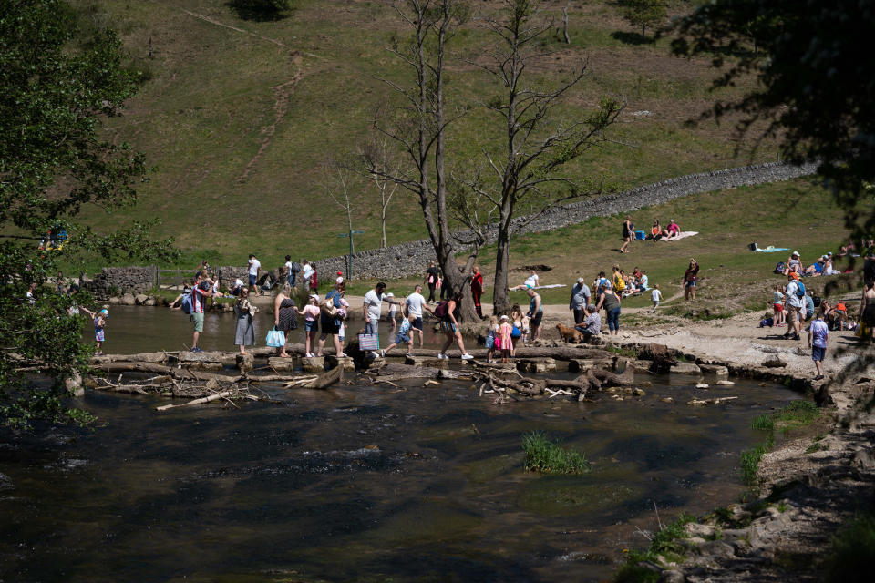 Sun worshipers flock to Dovedale in the Peak District to cool off in the water.