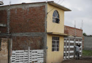 A cameraman films the drug rehabilitation center that was attacked in Irapuato, Mexico, Thursday, July 2, 2020. Gunmen burst into the center and opened fire Wednesday, killing 24 people and wounding seven, authorities said. (AP Photo/Eduardo Verdugo)