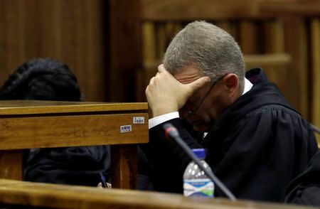 State prosecutor Gerrie Nel looks down as Judge Thokozile Masipa reads her verdict during an appeal hearing brought by prosecutors against the six-year jail term handed to Oscar Pistorius for the murder of his girlfriend Reeva Steenkamp in Johannesburg, South Africa, August 26, 2016. REUTERS/Themba Hadebe/Pool