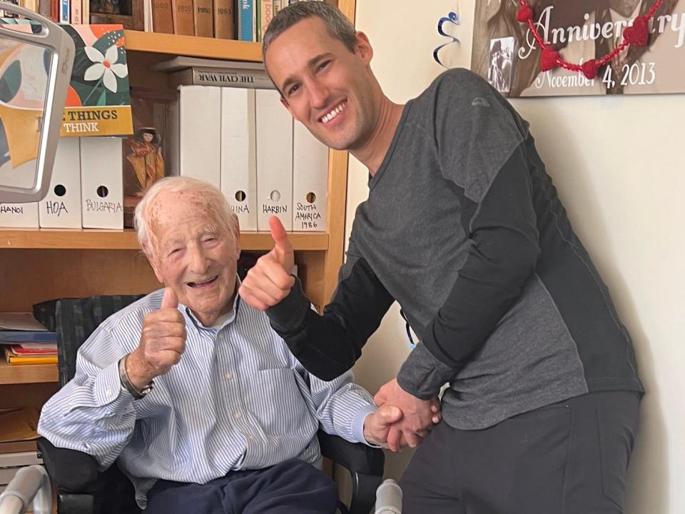 Morrie Markoff and his grandson Thomas Markoff hold their thumbs up to the camera