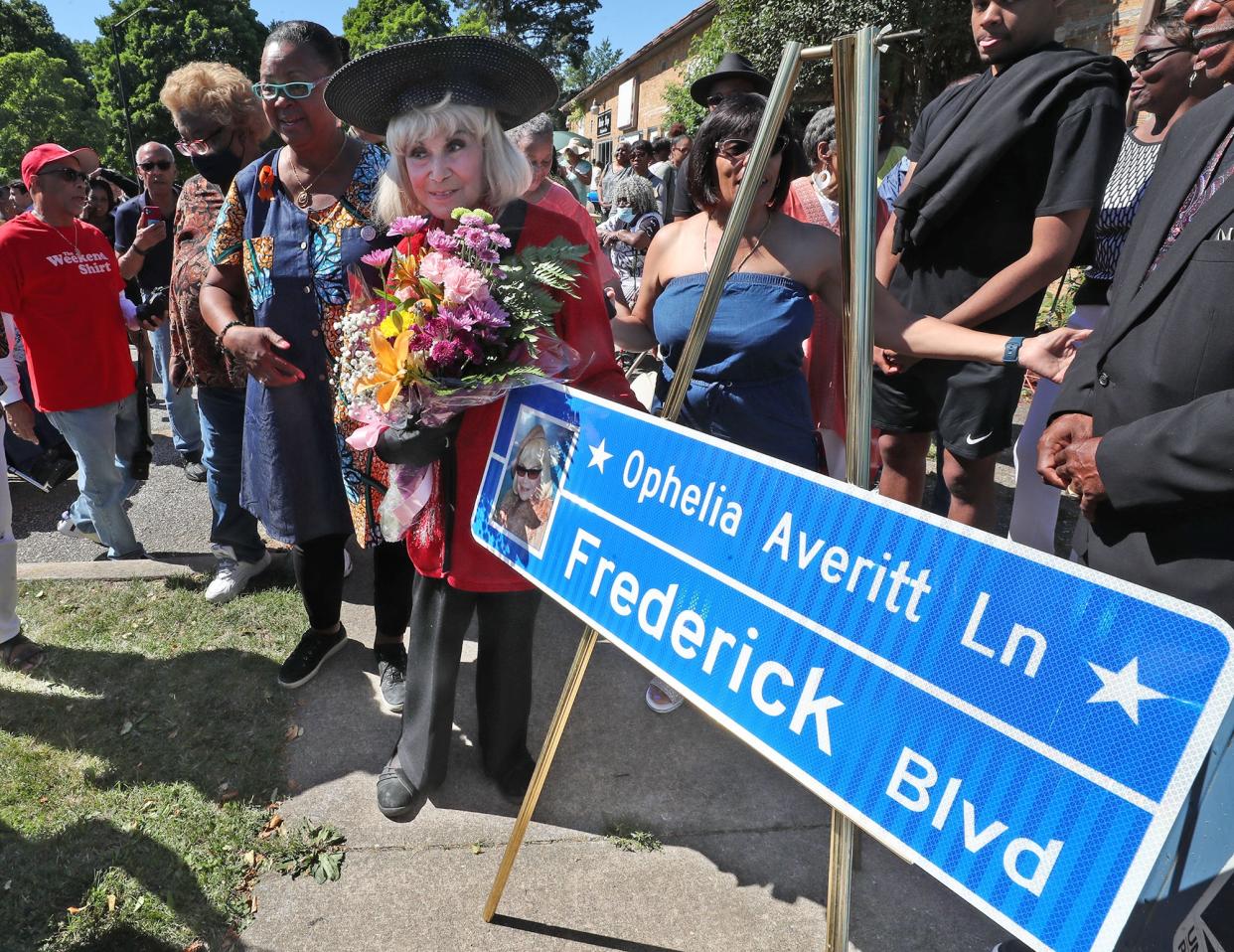 Ophelia Averitt looks at the comparative street sign during a ceremony designating the corner of Frederick Boulevard and Copley Road as Ophelia Averitt Lane in Akron on Saturday.