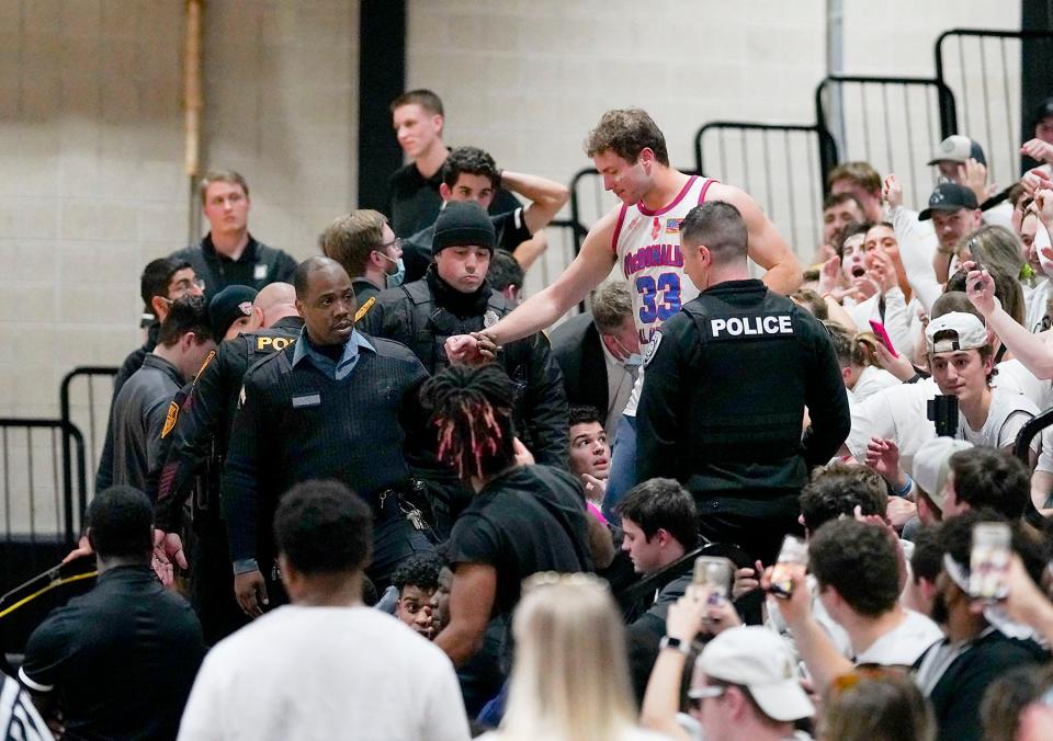 SMITHFIELD, RI—Northeast Conference Tournament—Wagner Seahawks vs Bryant Bulldogs.  PICTURED IS: A person seated in the student section was taken out of the stands and removed from the gym after an altercation in the second half.  Glenn Osmundson/Special to The Providence Journal