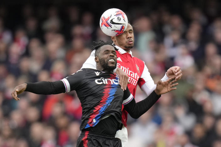 Arsenal's Gabriel, right, challenges for the ball with Crystal Palace's Jeffrey Schlupp during the English Premier League soccer match between Arsenal and Crystal Palace at Emirates stadium in London, Sunday, March 19, 2023. (AP Photo/Kirsty Wigglesworth)