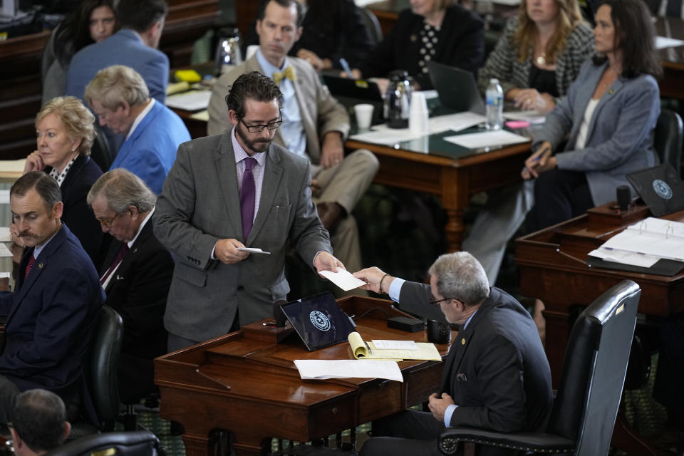 Votes are collected by Texas state senators acting as a jurors in the impeachment trial against suspended Texas Attorney General Ken Paxton in the Senate Chamber at the Texas Capitol, Saturday, Sept. 16, 2023, in Austin, Texas. (AP Photo/Eric Gay)