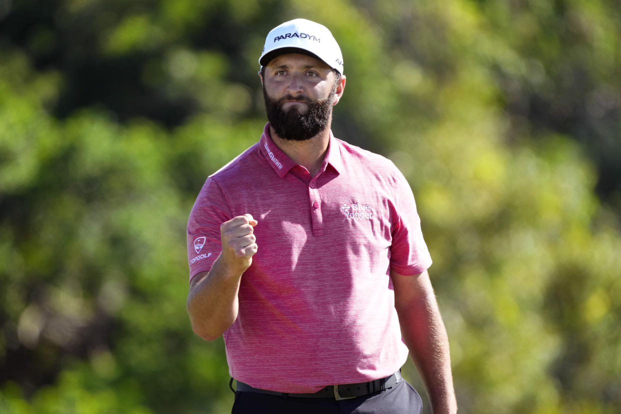 Jon Rahm, of Spain, celebrates his birdie putt on the 18th green during the final round of the Tournament of Champions golf event, Sunday, Jan. 8, 2023, at Kapalua Plantation Course in Kapalua, Hawaii. (AP Photo/Matt York)