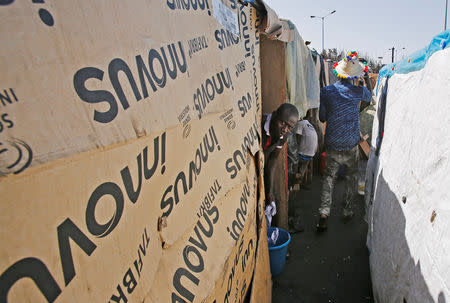 African migrant washes his clothes at a makeshift house on the outskirts of Casablanca, Morocco September 5, 2018. REUTERS/Youssef Boudlal