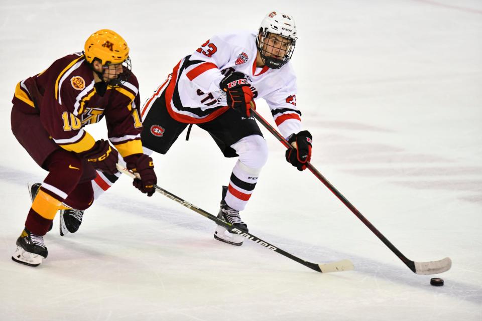 St. Cloud State's Jack Peart tries to get the puck past Tristan Broz of the University of Minnesota during the game Saturday, Oct. 16, 2021 at the Herb Brooks National Hockey Center in St. Cloud. 