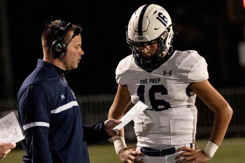 Seton Hall Prep head coach William Fitzgerald speaks with #16 Jack Gilmore during a game against Paramus Catholic on Friday, October 6, 2023.