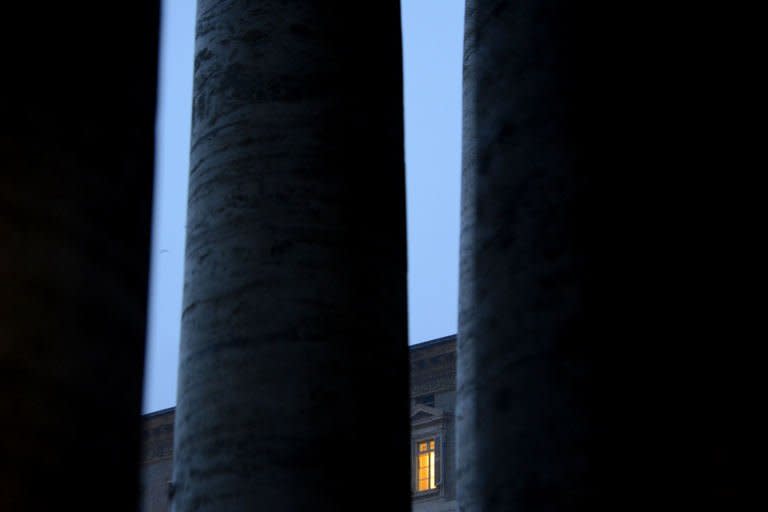 Pope Benedict XVI's apartments are lit up the evening after he resigned on February 11, 2013