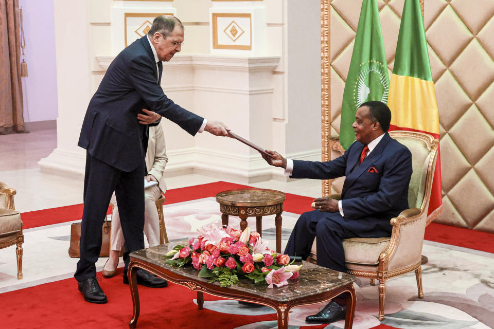 FILE - In this photo released by Russian Foreign Ministry Press Service, Russian Foreign Minister Sergey Lavrov, left, delivers Russian President Vladimir Putin's message to Republic of Congo's President Felix Tshisekedi during their meeting in Brazzaville, Congo, July 25, 2022. The Biden administration likes to say that Russia is now isolated internationally because of its invasion of Ukraine. Yet its top officials are hardly sitting lonely and isolated in the Kremlin and now the U.S. wants to talk. (Russian Foreign Ministry Press Service via AP, File)