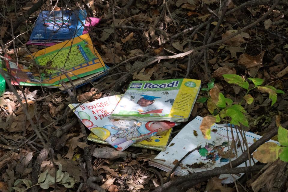 Children's books are seen Monday at a campsite in a wooded area north of Dillons at 2010 S.E. 29th St.