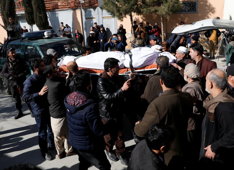 Relatives carry the body of one of the female judges shot dead by unknown gunmen in Kabul