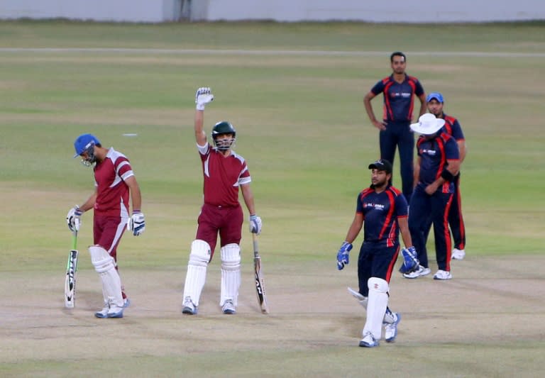 Asian labourers play cricket at the Asian Town Cricket Stadium on June 24, 2015, in the Qatari capital Doha