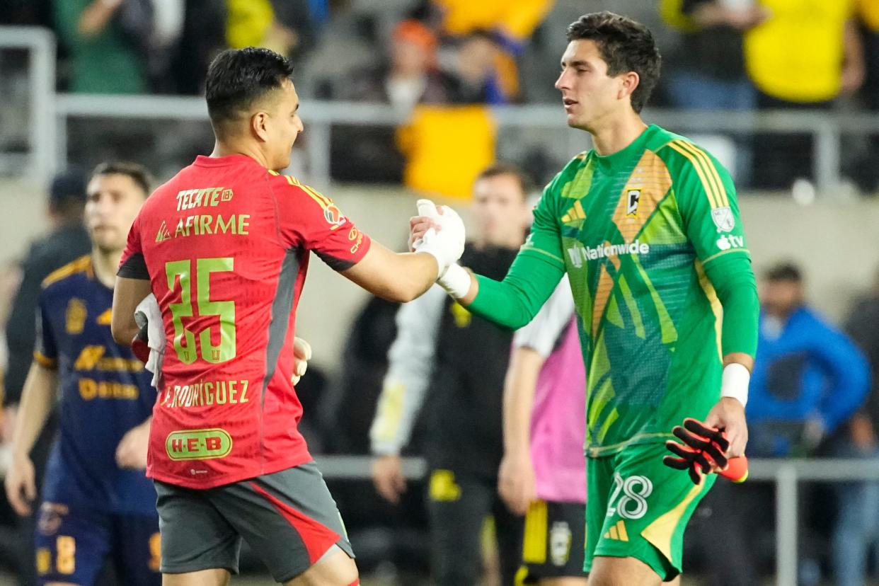 Apr 2, 2024; Columbus, OH, USA; Columbus Crew goalkeeper Patrick Schulte (28) shakes hands with Tigres UANL goalkeeper Carlos Felipe Rodriguez (25) following the Concacaf Champions Cup quarterfinal at Lower.com Field. . Mandatory Credit: Adam Cairns-USA TODAY Sports