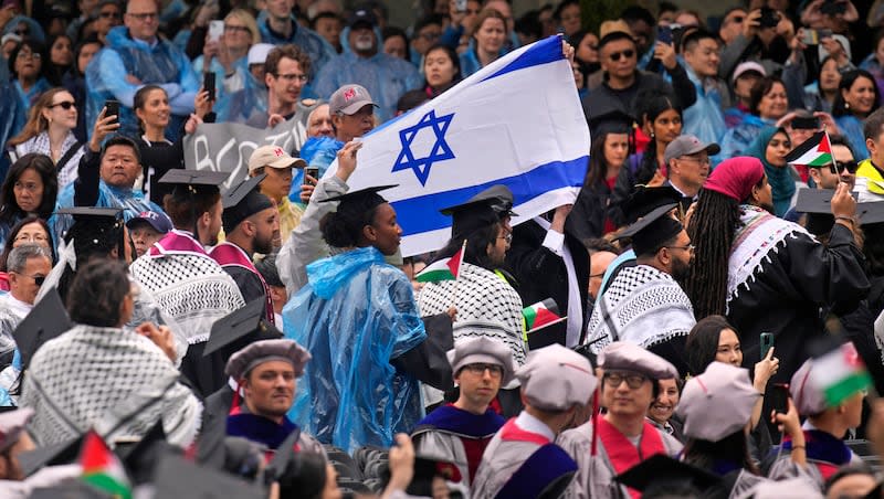 Pro-Palestinians graduating students pass the flag of Israel while walking out of commencement in protest at the Massachusetts Institute of Technology, Thursday, May 30, 2024, in Cambridge, Mass.